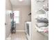 Convenient laundry room with washer, dryer, shelving and natural light from the window at 521 Mirramont Pl, Woodstock, GA 30189