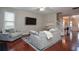 Open living room with hardwood floors, fireplace, and open access to other rooms in the house at 521 Mirramont Pl, Woodstock, GA 30189