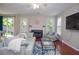 Bright living room with fireplace, comfortable seating, and sliding doors to the backyard allowing lots of natural light at 521 Mirramont Pl, Woodstock, GA 30189