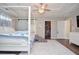Spacious bedroom boasts a four-poster bed, a ceiling fan, and a large walk-in closet at 521 Mirramont Pl, Woodstock, GA 30189