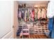 Organized walk-in closet with shelves, hanging rods, and shoe storage at 521 Mirramont Pl, Woodstock, GA 30189