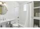 Bathroom featuring a tub and shower combination, white subway tile, and storage at 746 N Highland Ne Ave # 6, Atlanta, GA 30306