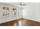 Empty bedroom with hardwood floors, white walls, shutters and a ceiling fan at 746 N Highland Ne Ave # 6, Atlanta, GA 30306