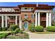 Elegant brick home with white columns, landscaped front yard, and blue front door at 746 N Highland Ne Ave # 6, Atlanta, GA 30306