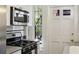 Bright kitchen featuring stainless steel range and microwave next to a windowed back door at 746 N Highland Ne Ave # 6, Atlanta, GA 30306