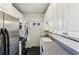 Galley kitchen with stainless appliances, plentiful white cabinets, and black tiled floor at 746 N Highland Ne Ave # 6, Atlanta, GA 30306
