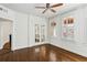 Open living room with hardwood floors, white trim, windows with shutters and glass french doors at 746 N Highland Ne Ave # 6, Atlanta, GA 30306