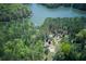 Aerial view of multiple homes nestled in the woods, each with private access to the beautiful lake at 934 Pine Cir, Woodstock, GA 30189