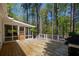 Inviting backyard deck and screened porch surrounded by lush trees and natural light at 934 Pine Cir, Woodstock, GA 30189
