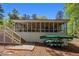 Home featuring a screened-in porch, backyard, stairs and space for kayaks and canoes at 934 Pine Cir, Woodstock, GA 30189