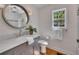 Updated bathroom features marble countertop, gray vanity, and round mirror at 934 Pine Cir, Woodstock, GA 30189