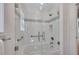 Modern bathroom features a glass-enclosed shower with white tile and gray accent at 934 Pine Cir, Woodstock, GA 30189