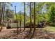 Charming home with a screened porch and garage surrounded by mature trees and a well-maintained yard at 934 Pine Cir, Woodstock, GA 30189