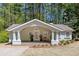 Charming home with inviting front porch, decorative arch, and well-maintained landscaping at 934 Pine Cir, Woodstock, GA 30189
