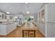 Bright kitchen featuring an island, built-in cabinets, an attached dining table, and hardwood floors at 934 Pine Cir, Woodstock, GA 30189