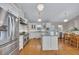 Open kitchen with stainless steel appliances, a central island, and an adjacent dining area at 934 Pine Cir, Woodstock, GA 30189