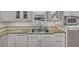 Kitchen with stone countertops, stainless steel appliances, and white cabinetry at 934 Pine Cir, Woodstock, GA 30189