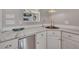 Kitchen area with granite countertops, stainless steel appliances, and white cabinets at 934 Pine Cir, Woodstock, GA 30189