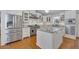 Bright kitchen with white cabinetry, stainless steel appliances, and hardwood floors at 934 Pine Cir, Woodstock, GA 30189