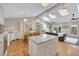 Bright kitchen featuring skylights, a large island, hardwood floors, and an open floor plan at 934 Pine Cir, Woodstock, GA 30189