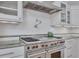 Kitchen detail showcasing stainless steel range with ornate backsplash and stainless hood at 934 Pine Cir, Woodstock, GA 30189