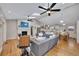 Open floor plan view of the living room and kitchen area with a fireplace and hardwood floors at 934 Pine Cir, Woodstock, GA 30189