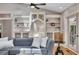 Bright living room with built-in shelves, a comfortable gray sofa, and a view of the patio at 934 Pine Cir, Woodstock, GA 30189