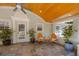 Beautiful outdoor patio with slate floor, wood ceiling, and comfortable seating at 934 Pine Cir, Woodstock, GA 30189