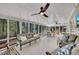 Large screened porch with outdoor seating, ceiling fans, and serene views of the surrounding trees at 934 Pine Cir, Woodstock, GA 30189