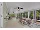 Spacious screened-in porch with views of nature, featuring multiple seating areas and ceiling fans at 934 Pine Cir, Woodstock, GA 30189