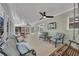 Relaxing screened porch with comfortable furniture, ceiling fans, and an outdoor TV at 934 Pine Cir, Woodstock, GA 30189