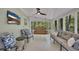 Inviting screened porch with comfortable seating, ceiling fan, TV, and a charming porch swing at 934 Pine Cir, Woodstock, GA 30189