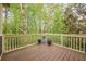 A lovely wooden back deck with potted plants and a view of the surrounding trees and foliage at 1745 Mary Lou Ln, Atlanta, GA 30316