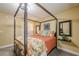 Bedroom featuring neutral color walls and carpet, with a four poster bed and decorative mirrors at 1745 Mary Lou Ln, Atlanta, GA 30316