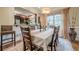 Elegant dining room with a long table, stylish seating, and ample natural light from the window at 1745 Mary Lou Ln, Atlanta, GA 30316