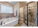 Relaxing main bathroom with a soaking tub, glass shower, and decorative tile accents at 1745 Mary Lou Ln, Atlanta, GA 30316