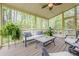 Relaxing screened-in porch with comfortable seating and views of the lush backyard at 1745 Mary Lou Ln, Atlanta, GA 30316