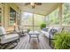 Relaxing screened-in porch with comfortable seating and views of the lush backyard at 1745 Mary Lou Ln, Atlanta, GA 30316