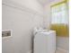 Compact laundry room features a washer and shelving for efficient organization at 2550 Columbia Crossing Ct, Decatur, GA 30034