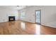 Bright living room with hardwood floors features a fireplace and easy access to the backyard at 2550 Columbia Crossing Ct, Decatur, GA 30034