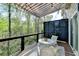 Relaxing covered balcony with wooded views, privacy screen, and outdoor furniture at 2685 Maple Park Pl # 27, Cumming, GA 30041