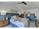 Bedroom featuring floral bedspread, wood floors, access to walk in closet, and a dark blue accent wall at 2685 Maple Park Pl # 27, Cumming, GA 30041