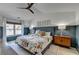 Bedroom featuring unique floral bedding, stylish furnishings, ceiling fan, and lots of natural light at 2685 Maple Park Pl # 27, Cumming, GA 30041