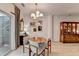 Bright dining room with hardwood floors, decorative mirror, dining table, and easy access to the backyard at 2685 Maple Park Pl # 27, Cumming, GA 30041