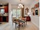 Inviting dining space features a wood table, natural light, decorative mirror, and sliding door to the outside at 2685 Maple Park Pl # 27, Cumming, GA 30041