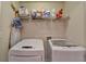 Functional laundry room features a wire shelf above modern washer and dryer units for ample storage at 2685 Maple Park Pl # 27, Cumming, GA 30041