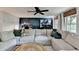 Living room featuring a comfortable sectional sofa, dark accent wall, and modern lighting at 2685 Maple Park Pl # 27, Cumming, GA 30041