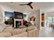 Cozy living room with a fireplace, unique ceiling fan, and sliding glass doors at 2685 Maple Park Pl # 27, Cumming, GA 30041