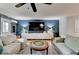 Stylish living room with a large sectional sofa, modern media center, and unique wall design at 2685 Maple Park Pl # 27, Cumming, GA 30041