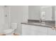 Well-lit bathroom with granite countertops, white cabinets, modern fixtures, and a shower-tub combination at 288 Overlook Rd, Covington, GA 30014